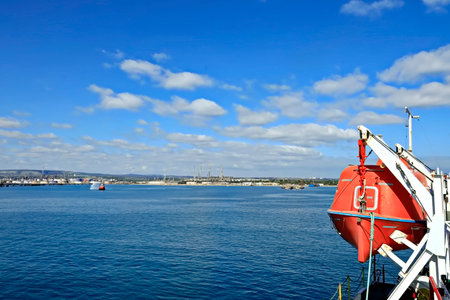 Red life buoy on the deck of a ferry boat in the sea