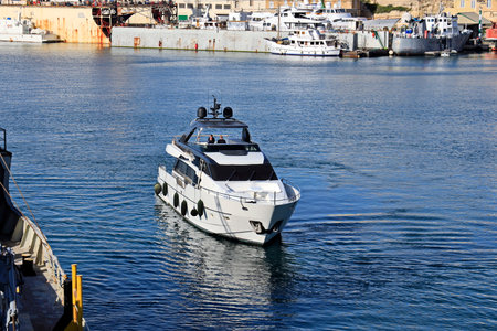White motor yacht in the port of Marsaxlokk, Maltaの写真素材