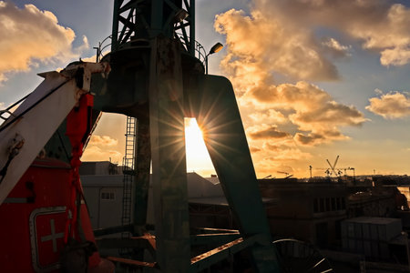 Industrial landscape with cranes and sunset sky. Industrial background.の写真素材