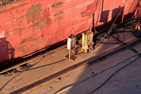 Cargo terminal for loading bulk cargo of iron ore by ship cranes and grabs.