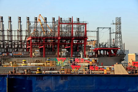 Petrochemical plant and cranes on the background of blue sky