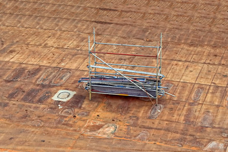 construction site with scaffolding on wooden floor, closeup of photoの写真素材