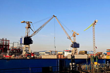 Port cargo crane and bulk carrier, Odessa, Ukraine, on blue sky background
