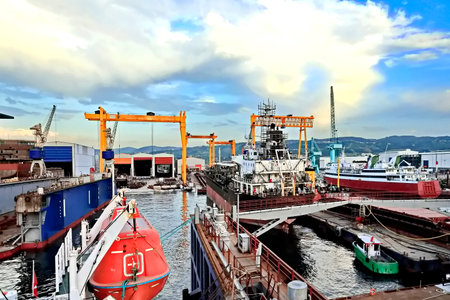 Port terminal for loading bulk cargo by ship cranes and grabs. Seaport for loading bulk cargo by...