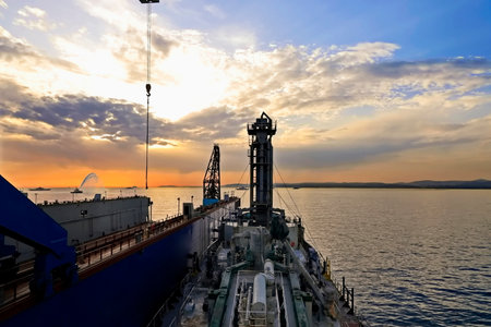 Oil and gas industry. Oil drilling rig in the sea at sunset.