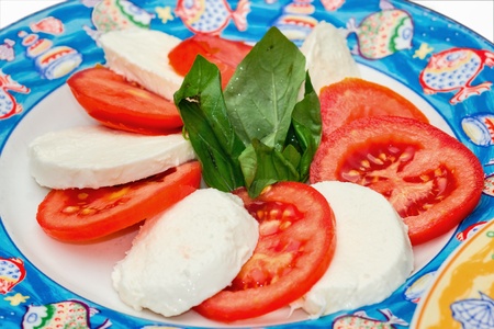 Caprese. Tomato and mozzarella salad with basil.
の写真素材