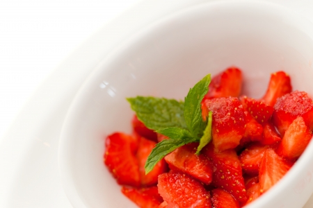 Fresh cutted strawberry in a bowl with sugar and lemon juicwe.の写真素材