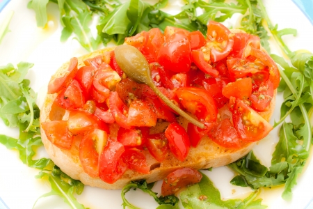 Fresh bruschetta with tomato, basil and caper の写真素材