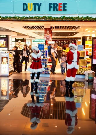 BARCELONA, SPAIN - DECEMBER 22  A men and a women in Santa clothing entertaining customer at duty free shop in the airport on December 22, 2011 in Barcelona, Spain  のeditorial素材