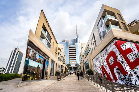 MILAN, ITALY - OCTOBER 15,2014:  Traditional milanese historic house in the foreground with the new modern glass building of Unicredit in the background, Porta Nuova Area.のeditorial素材