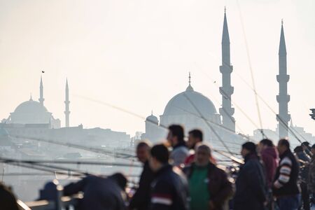 ISTANBUL, TURKEY - DECEMBER 28, 2018: People fishing at Galata Bridge in a sunny day, Beyoglu, Istanbul, Turkey.のeditorial素材