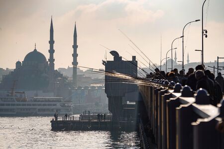 ISTANBUL, TURKEY - DECEMBER 28, 2018: People fishing at Galata Bridge in a sunny day, Beyoglu, Istanbul, Turkey.のeditorial素材