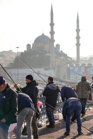 ISTANBUL, TURKEY - DECEMBER 28, 2018: People fishing at Galata Bridge in a sunny day, Beyoglu, Istanbul, Turkey.のeditorial素材