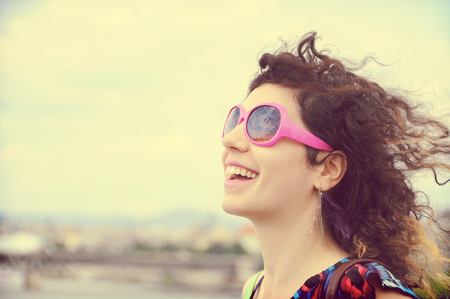 Smiling girl with sunglasses enjoying on sunnyday wallking by the Danube River in Budapest, Hungaryの写真素材