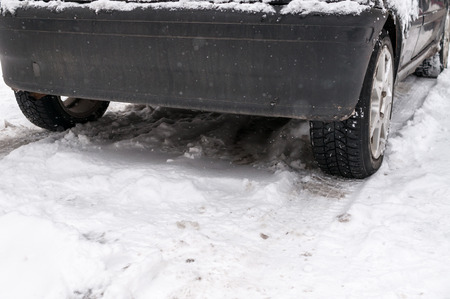 Lower part of a car on the snowの写真素材