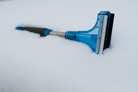 Closeup of snow and ice car cleaner in the snowの写真素材
