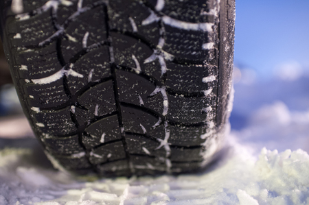 Closeup of winter tyre on the road, selective focus, shalow depth of fieldの写真素材