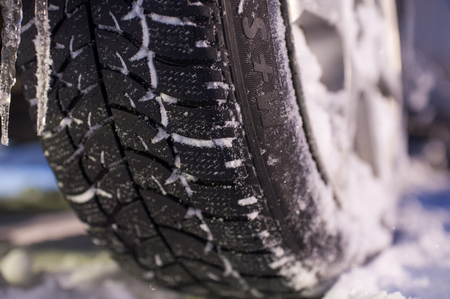 Closeup of winter tyre on the road, selective focus, shalow depth of fieldの写真素材