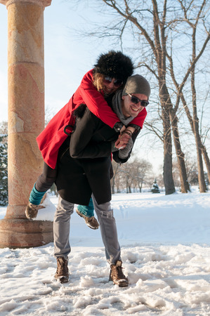 Young couple having fun on the snowの写真素材