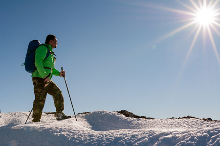Hiker relaxing on top of hill and enjoying on sunny dayの写真素材