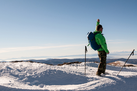 Cheerful man hiker on top of mountainの写真素材