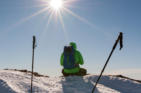 Hiker relaxing on top of hill and enjoying on sunny dayの写真素材