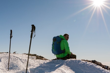 Hiker relaxing on top of hill and enjoying on sunny dayの写真素材