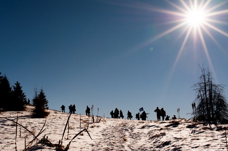 A Silhouette group of people on the top of the mountainの写真素材
