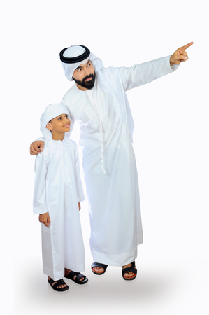 arab father and son wearing emirati traditional dressの写真素材