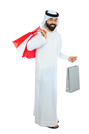 arab man wearing emirati traditional dress shoppingの写真素材