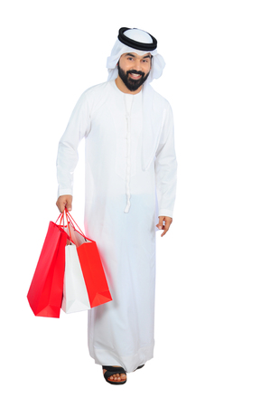 arab man wearig emirati traditional dress (waliking after shopping)の写真素材