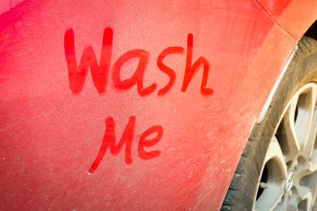 dirty red car was written "Wash Me"の写真素材
