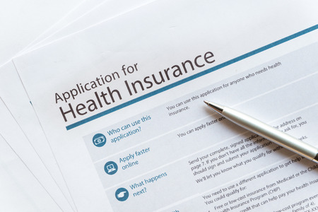 Health insurance paper form with silver pen concept life planing.の写真素材