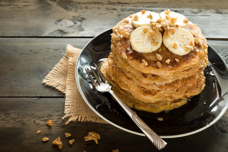 Banana pancake home made healthy easily breakfast with garnola topping and organic honey.の写真素材