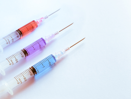 syringe arranged on white background with tone.の写真素材