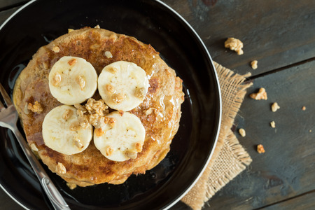 Banana pancake home made healthy easily breakfast with garnola topping and organic honey.の写真素材