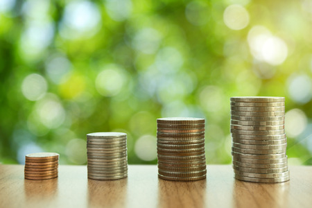 money stacks are arranged from small coins to big coins that mean growing of money with nature bokeh background for feel relax,concept simply and happy investment.の写真素材