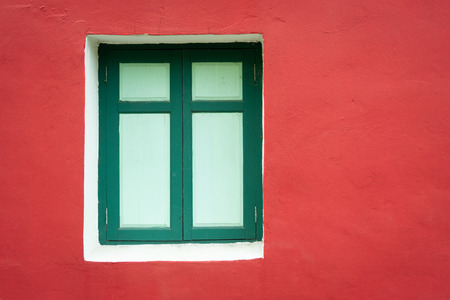 Green window frame with red cement wall vintage style.