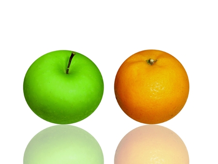 apple and orange on white glassの写真素材