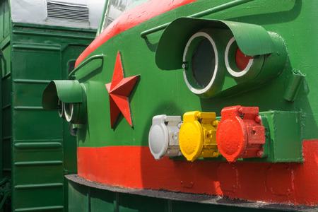 close up front of green electric locomotive with red starの写真素材