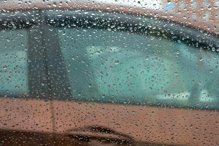 view to broun car door through rain dropsの写真素材