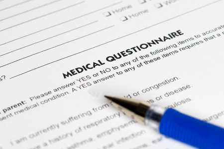 medical questions with opened blue penの写真素材