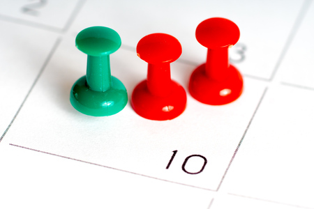 green red pins on calendar grid 10 juneの写真素材