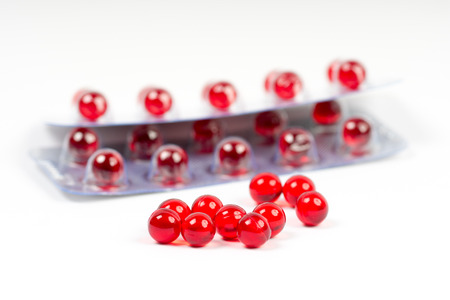 vitamin e capsules and two blister packs on whiteの写真素材