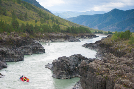 small rafting in rapid mountain river among rocksの写真素材