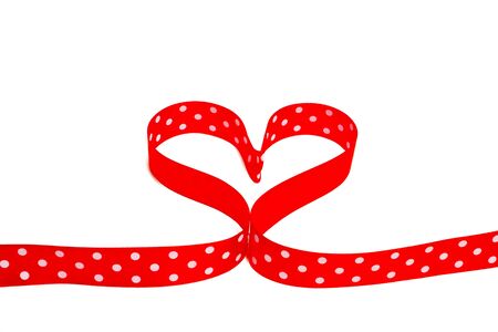 heart shaped polka dot red ribbon on white backgroundの写真素材
