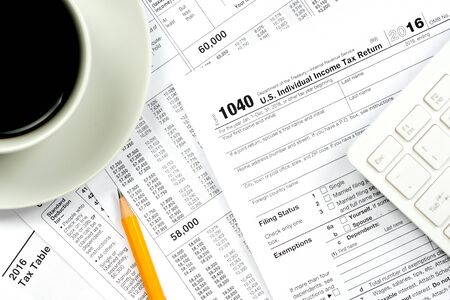 1040 tax forms top view with coffee cup and pencilの写真素材