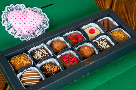 delicious chocolate candies in gift box with textile heartの写真素材