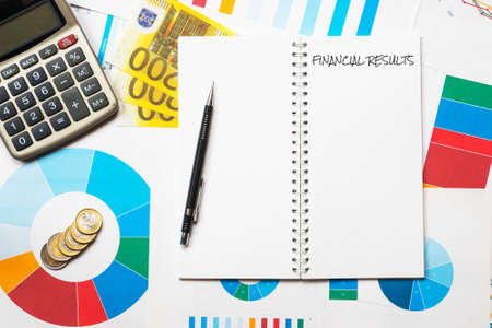 financial results title on colorful charts, calculator and euro money backgroundの写真素材