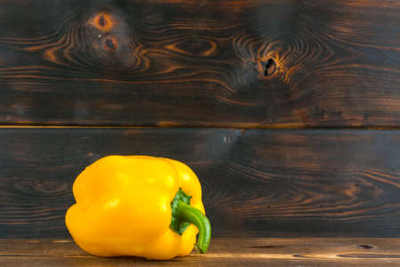 yellow bell pepper on wooden backgroundの写真素材